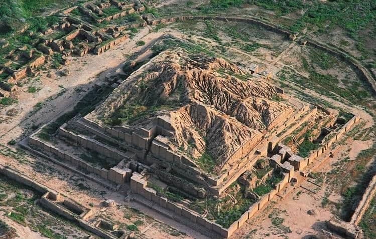 • Standing before the monumental Ziggurat of Chogha Zanbil.