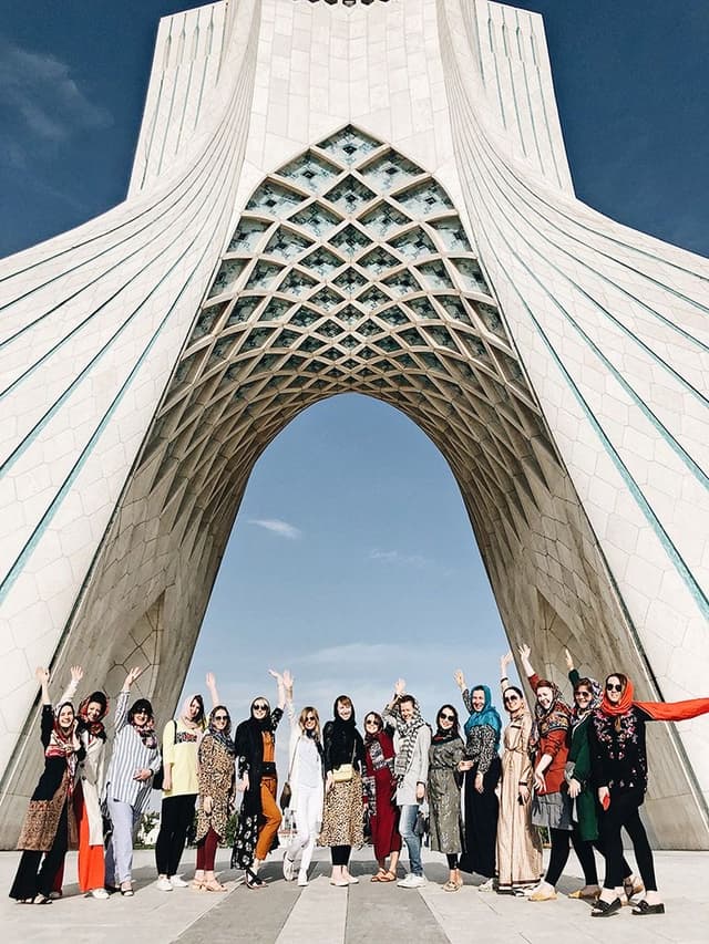 Group tour visiting ancient ruins in Iran