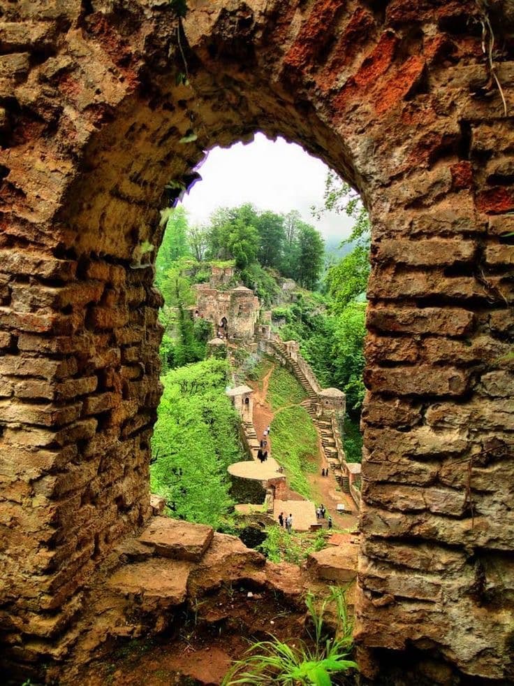 •	Rudkhan Castle hidden in lush greenery